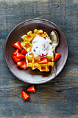 Belgian waffles with strawberries and ice cream (seen from above)