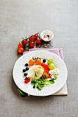 Smoked salmon with a poached egg, ricotta, salad and fruit