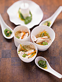 Noodle soup with chicken, vegetables and herb pesto