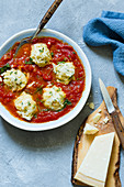 Steamed rocket and ricotta balls in tomato sauce