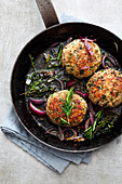 Veal meatballs with herbs and red onions in a pan