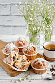 Muffins with chocolate and powdered sugar, served with tea