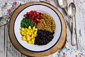 Ingredients for Buddha bowl with quinoa, beans, pepper and mango