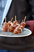Grilled sausages with honey and mustard sauce on pretzel sticks