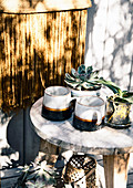 Cups and potted plants on wooden stools