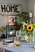 Sunflowers on table set for autumn meal