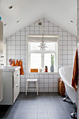 White wall tiles in attic bathroom