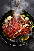 A T-bone steak sauteed with herbs