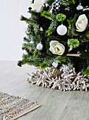 Wreath of beach ware under a decorated Christmas tree