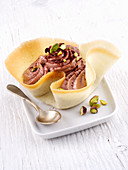 Chocolate cream with pistachios in a tuile bowl