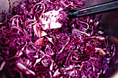 Red cabbage being mixed