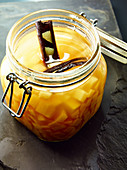 Quince ragout with cinnamon in a preserving jar