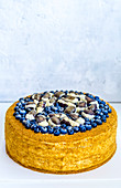 A blueberry cake decorated with chocolates