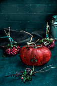 A pumpkin and bunches of berries