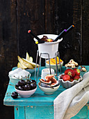 Chocolate fondue with fruit and marshmallows