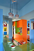 Orange cupboards and green breakfast bar in kitchen with blue walls