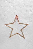 Star made from folding rule on white wall