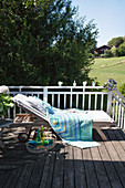 Crocheted blanket on lounger on balcony