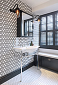 Patterned wall in classic black-and-white bathroom