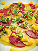 Red and yellow beet carpaccio with orange and olive oil emulsion