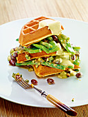 Potato waffles with bean melange and curry cream