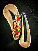 Courgette stuffed with bulgur vegetables and figs on tandoori yoghurt