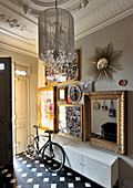 Stucco ornamentation and gilt picture frames in foyer of period apartment