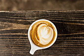 A caffe latte with a milk foam pattern