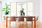 Dining table with designer chairs in a bright dining room