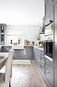 Country-house kitchen with grey panelled cabinets