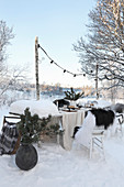 Set table with Christmas decorations in snow
