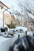 Set table with Christmas decorations in garden