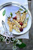 Fried bird cherry flowers with cherry compote