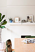 Dining table with chairs in front of a fireplace and houseplant