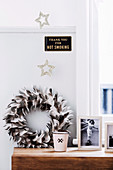 Feather wreath, framed photo, star decoration and sign in the bedroom
