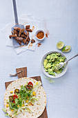 Ingredients for burritos with steak and guacamole