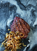 Grilled beef fillet steak with onions