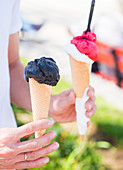 Black vanilla ice cream in a cone