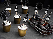 Chocolate cups with cream and plums infused in wine