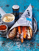 French fries and sweet potato fritters in a paper bag with parmesan and mayonnaise
