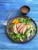 Apple and orange salad with roasted duck breast