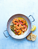 Fried prawns with rosemary in a pan
