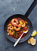 Mediterranean fried prawns with peppers, tomatoes and rosemary