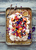 Pavlova with fruit, berries and a passion fruit topping