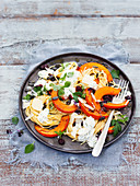 Spaghetti with baked pumpkin wedges and a yoghurt and herb sauce