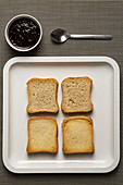 Four slices of zwieback (rusk) with jam