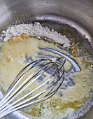 Flour being stirred into hot butter
