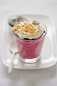 Pudding with wild berries, whipped cream, nuts and dragon fruit