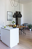 White island counter and rustic dining table in open-plan kitchen