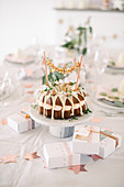 Bundt cake with garland on modern table set for Christmas